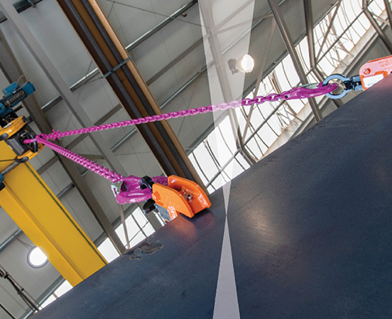 Steel plate lifting clamp securely gripping heavy steel plate